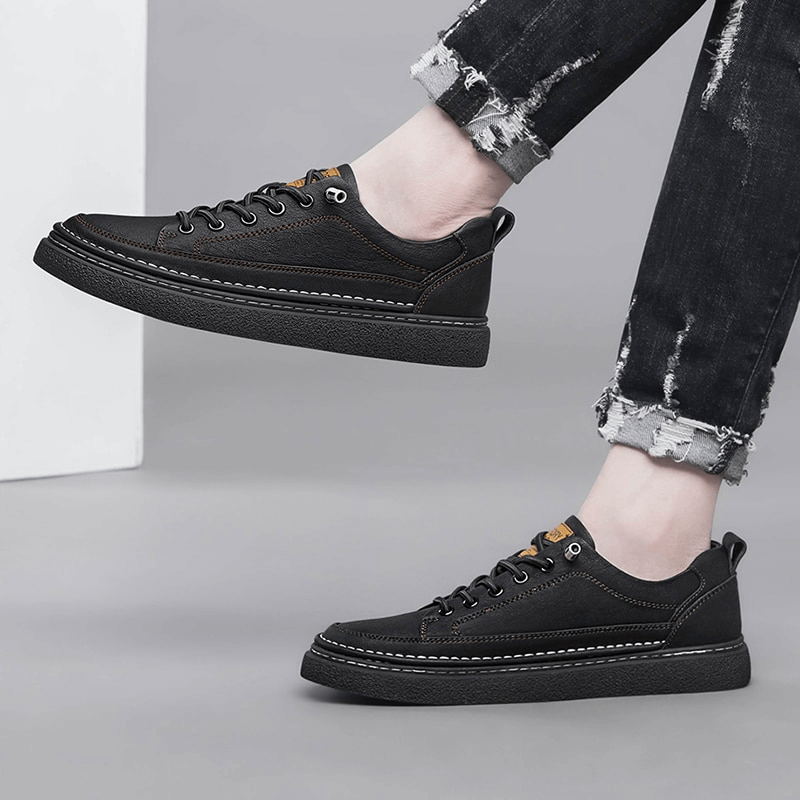 Stylish Leather Breathable Men's Sneakers SF1182, black design, lace-up, rubber sole, worn with ripped jeans, perfect for casual and athletic use.